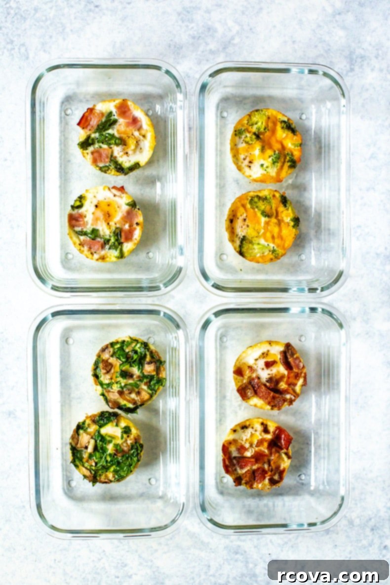 Make-Ahead Egg Bakes 9 Four meal prep containers, arranged in two rows, each containing a pair of distinct baked egg varieties, showcasing organized and flavorful breakfast preparation.