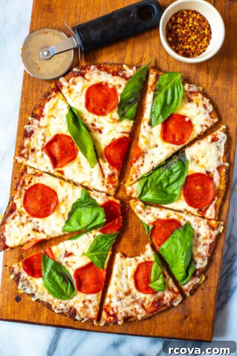 Ultimate 3-Ingredient Cauliflower Pizza Crust 2 Cauliflower Crust Pizza topped with vibrant pepperoni and fresh basil, ready to be enjoyed.