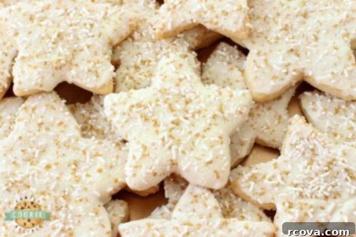 Festive Star Delights 2 Bright, buttery, and sparkly vanilla shortbread star cookies adorned with candy coating and festive sprinkles, perfect for holiday celebrations.