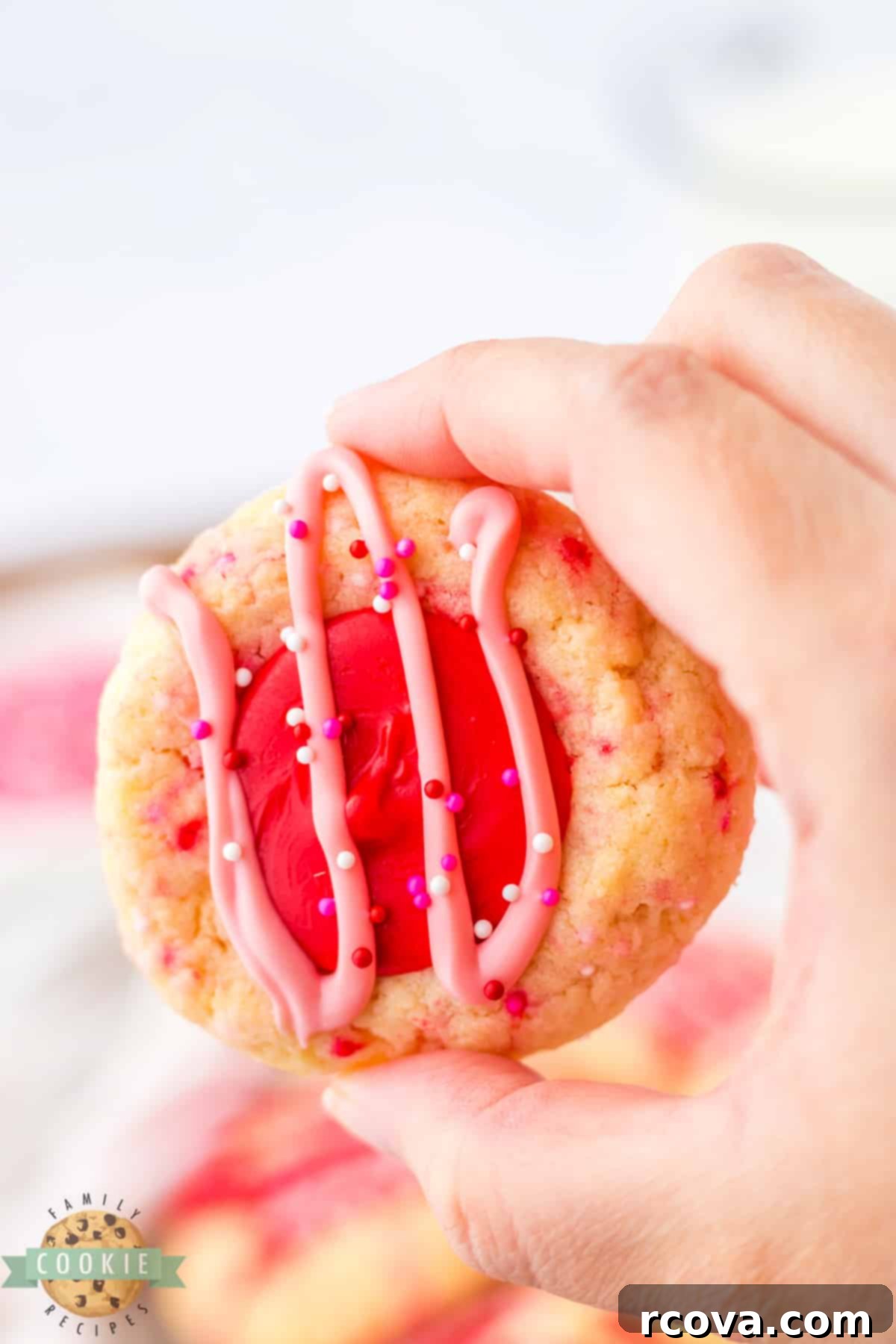 Valentines Thumbprint Cookies 4 Baked thumbprint cookie filled with melted red chocolate.