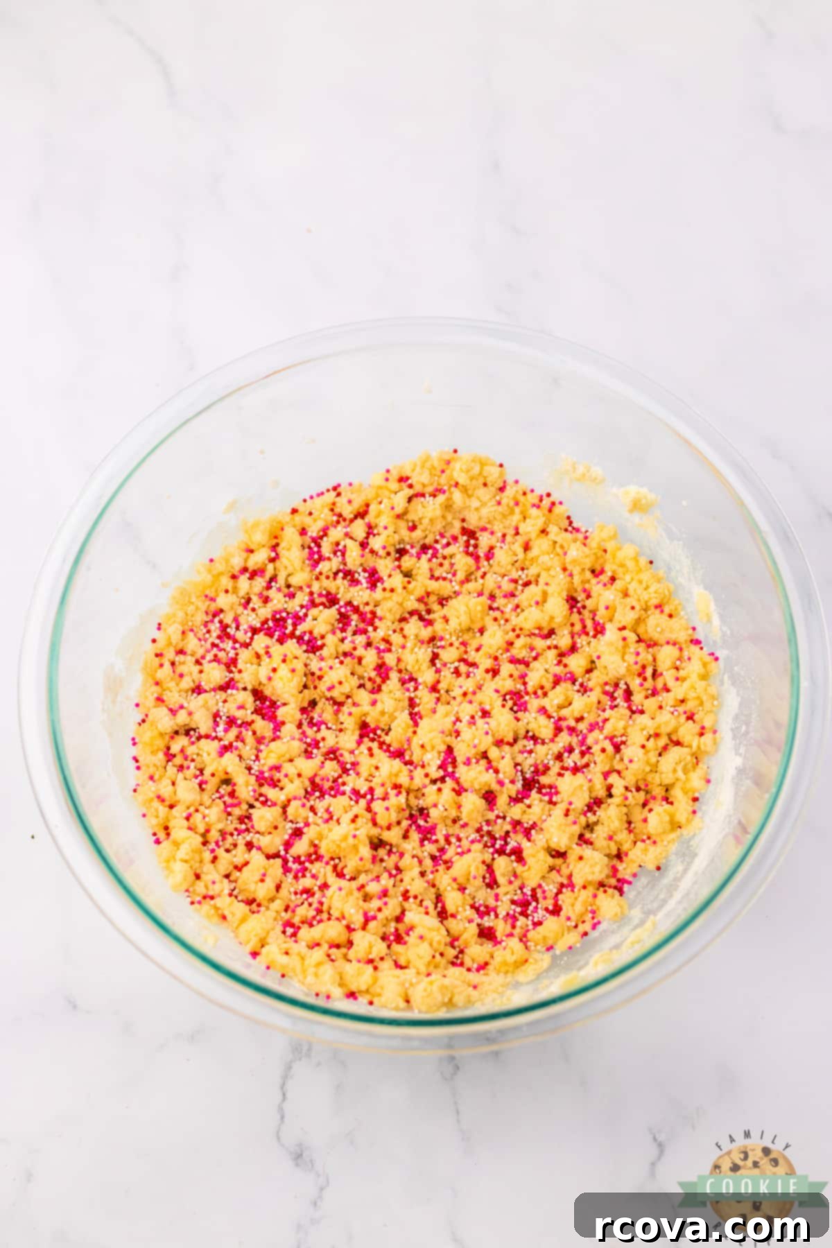 Valentines Thumbprint Cookies 6 Adding sprinkles to the cookie dough.
