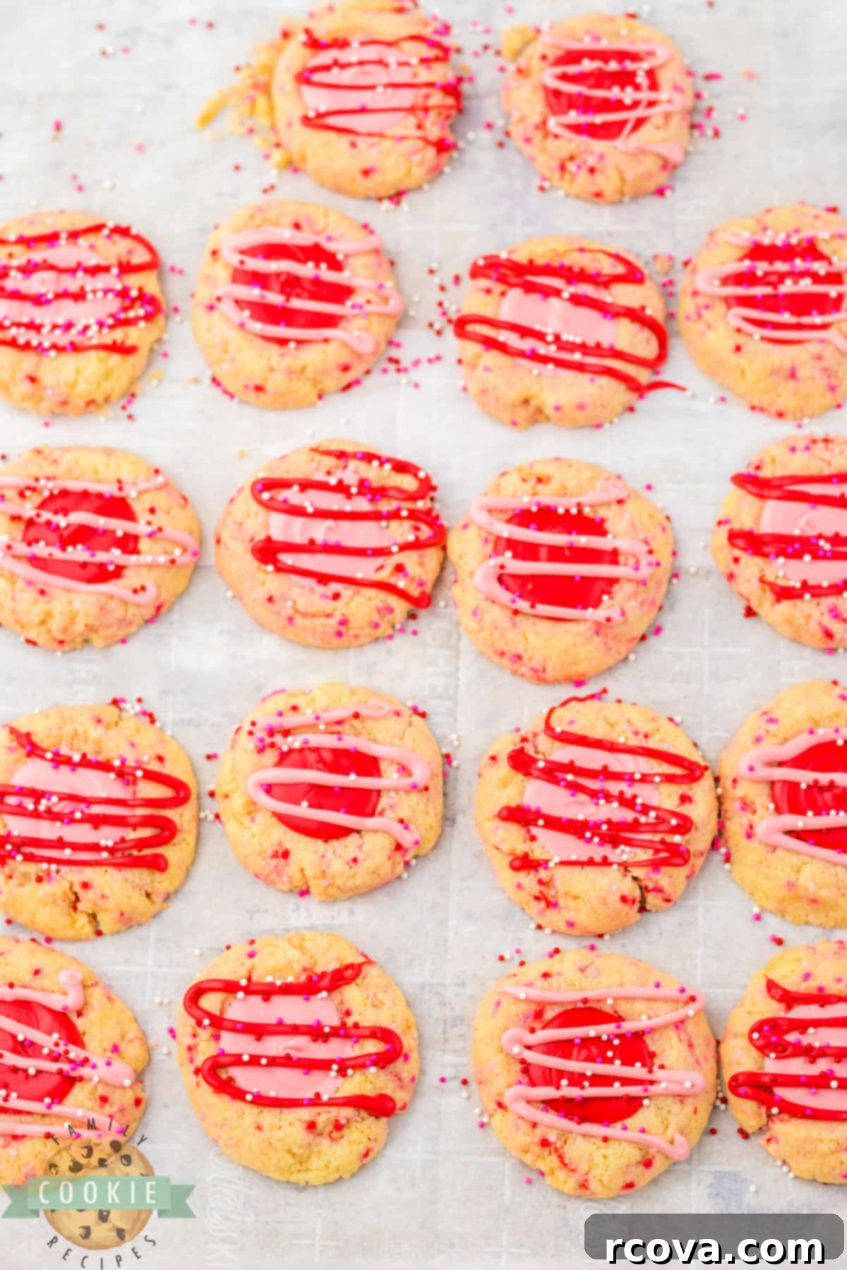 Valentines Thumbprint Cookies 10 Adding decorative drizzle and more sprinkles to the finished Valentine's Thumbprint Cookies.