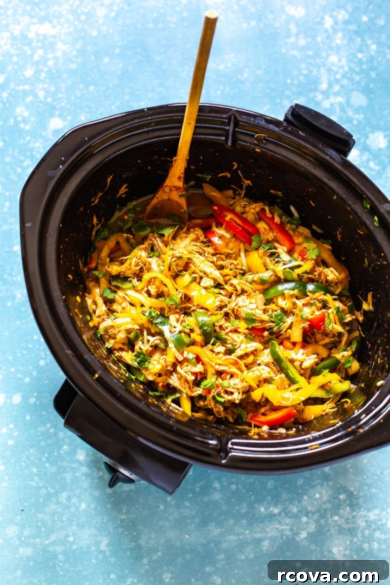 One-Pot Wonder Chicken Fajitas 2 Shredded chicken fajitas simmering in a crockpot, ready to be served.