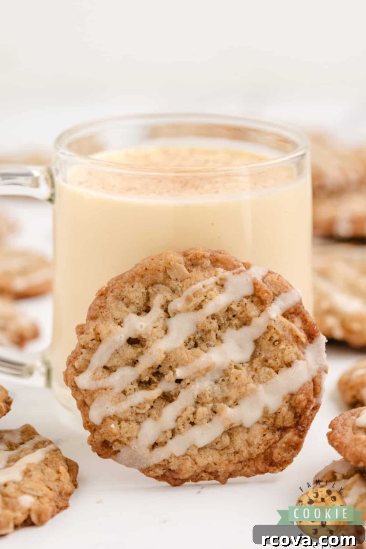 Spiced Eggnog Oatmeal Cookies 5 A freshly baked Eggnog Oatmeal Cookie placed next to a glass of creamy eggnog, highlighting the festive pairing.