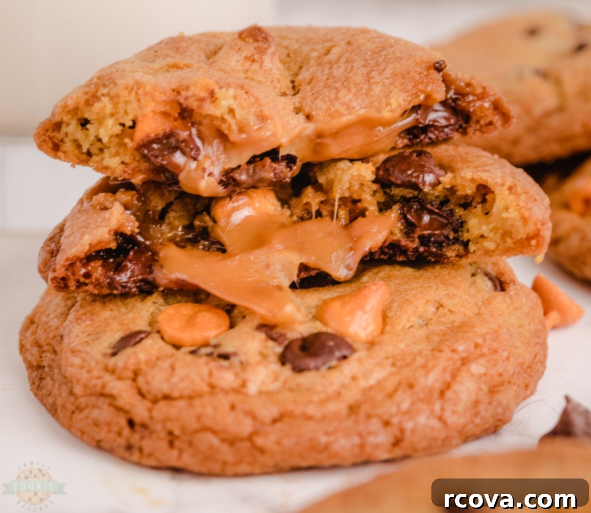 Chocolate Chip Cookies with a Gooey Caramel Heart 2 Freshly baked Caramel Chocolate Chip Cookies on a cooling rack, showing their golden brown exterior and hints of melted chocolate and caramel.