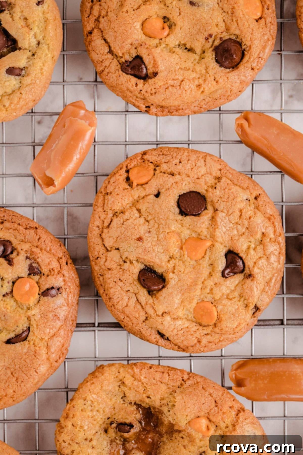 Chocolate Chip Cookies with a Gooey Caramel Heart 8 Delicious Caramel Chocolate Chip Cookies stacked, with a bite taken out of one to show the gooey caramel.