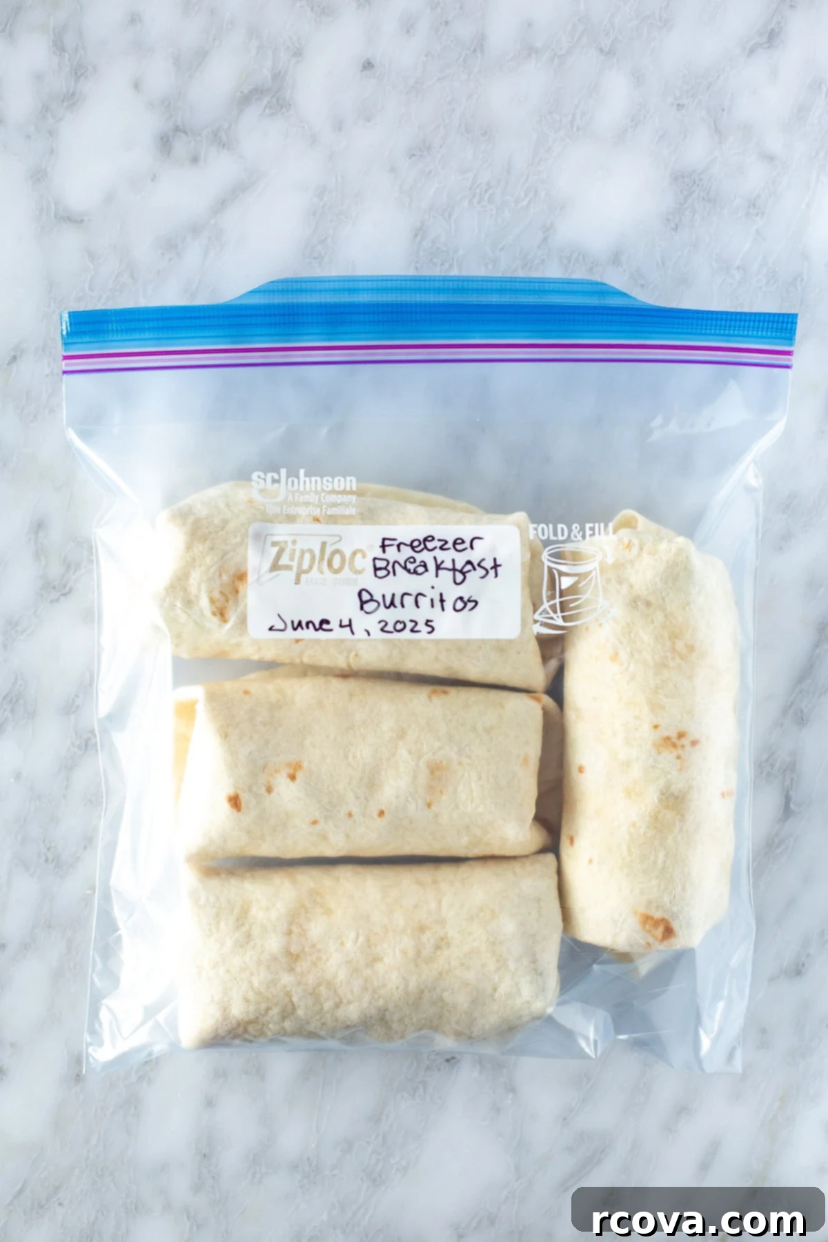 Ultimate Grab-and-Go Breakfast Burritos 10 Overhead shot of breakfast burritos neatly arranged in a zipper bag, ready for freezer storage.