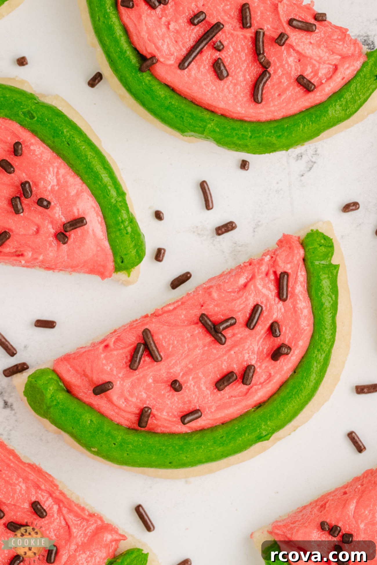 Summer Kissed Watermelon Cookies 6 darling pink and green frosted watermelon cookies on a wire rack to cool