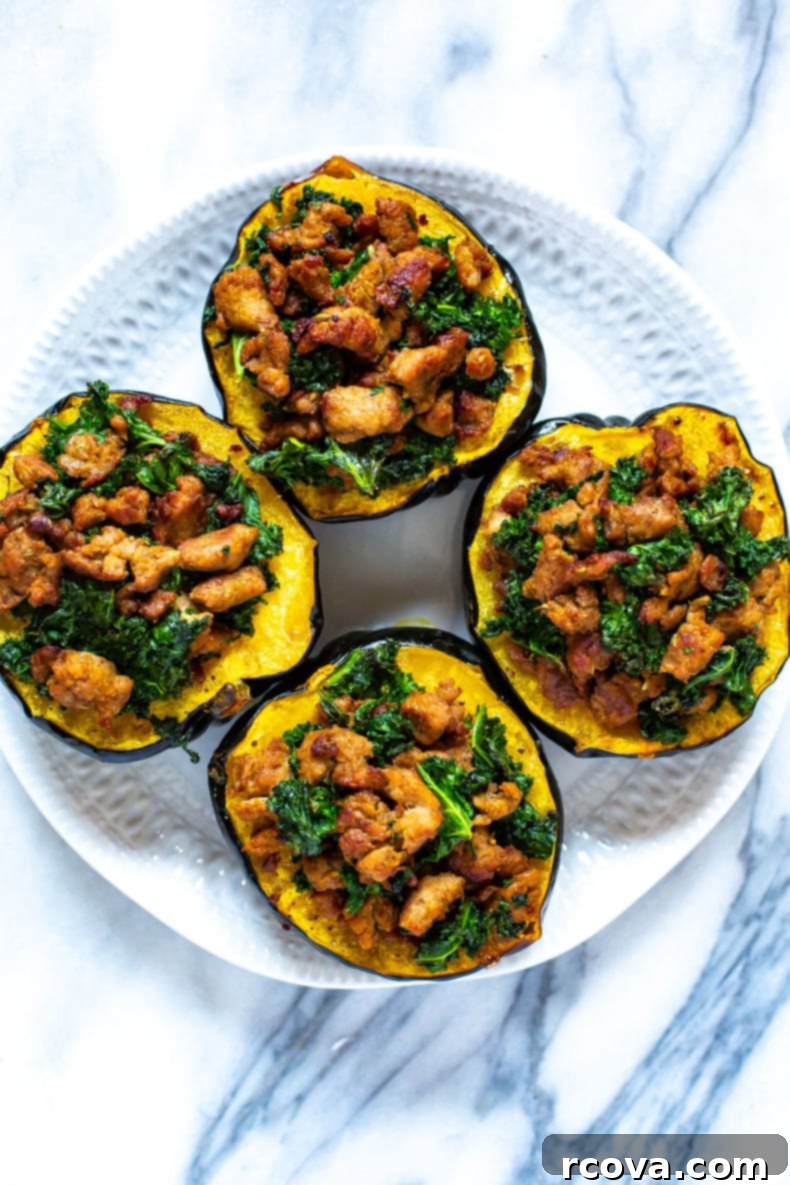 Savory Sausage and Kale Stuffed Acorn Squash 8 A beautifully presented serving of stuffed acorn squash on a plate, garnished and ready to enjoy.