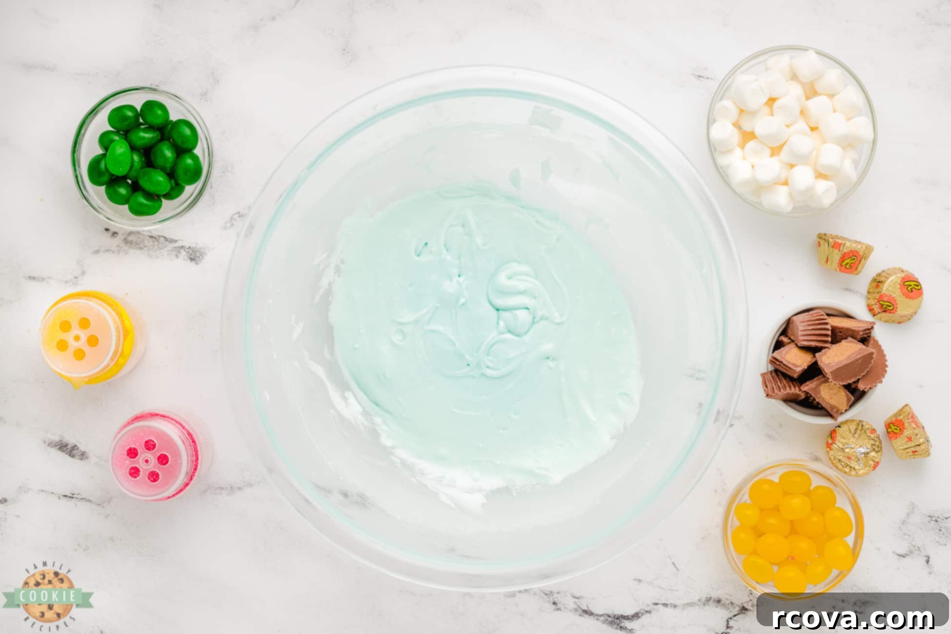 Marshmallow Blossom Cookies 5 A bowl of light blue frosting, ready to decorate the sugar cookies for a Spring theme.