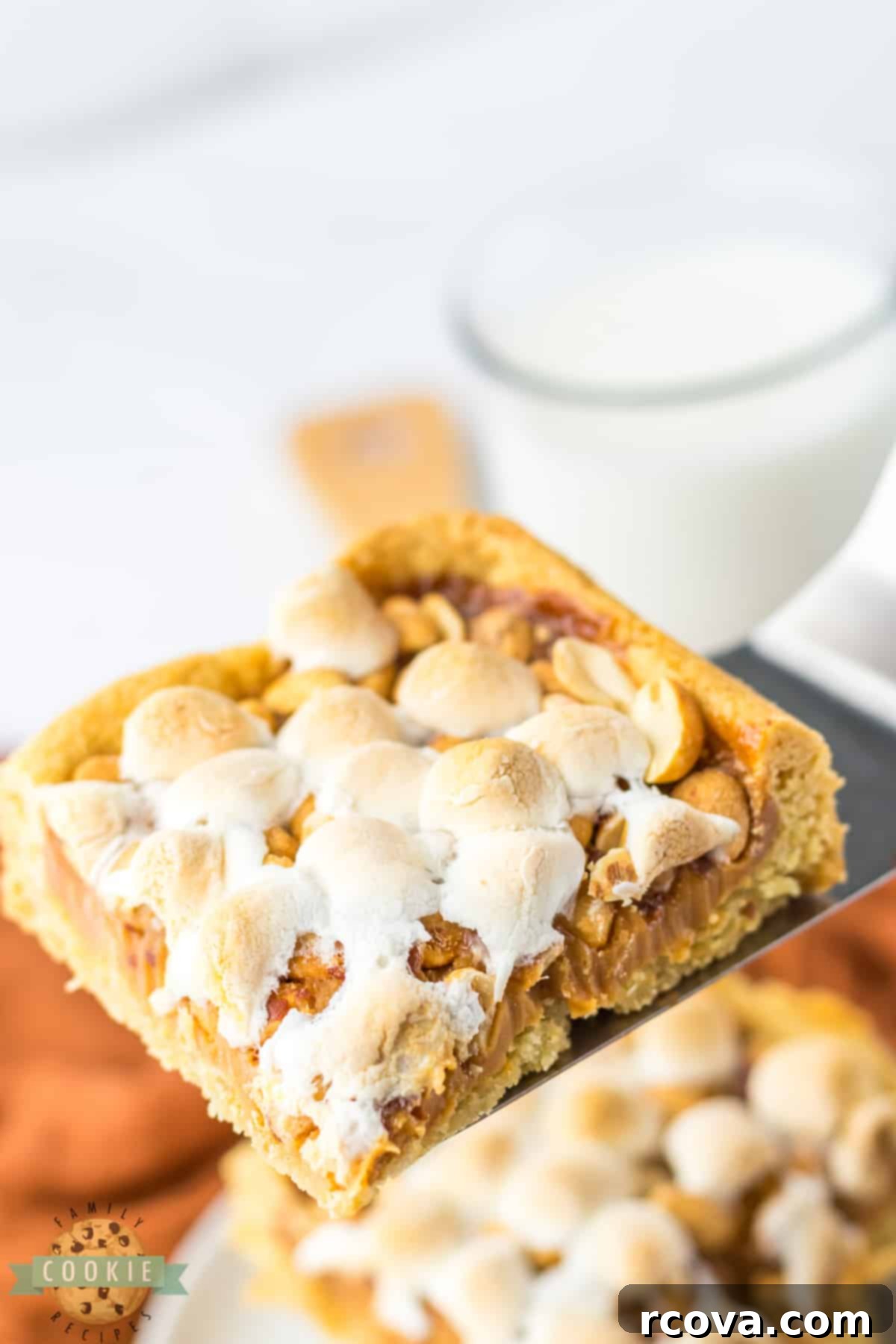 Irresistible Peanut Caramel Cookie Bars 3 Close-up of sugar cookie bars featuring a topping of peanuts, gooey marshmallow, and rich caramel