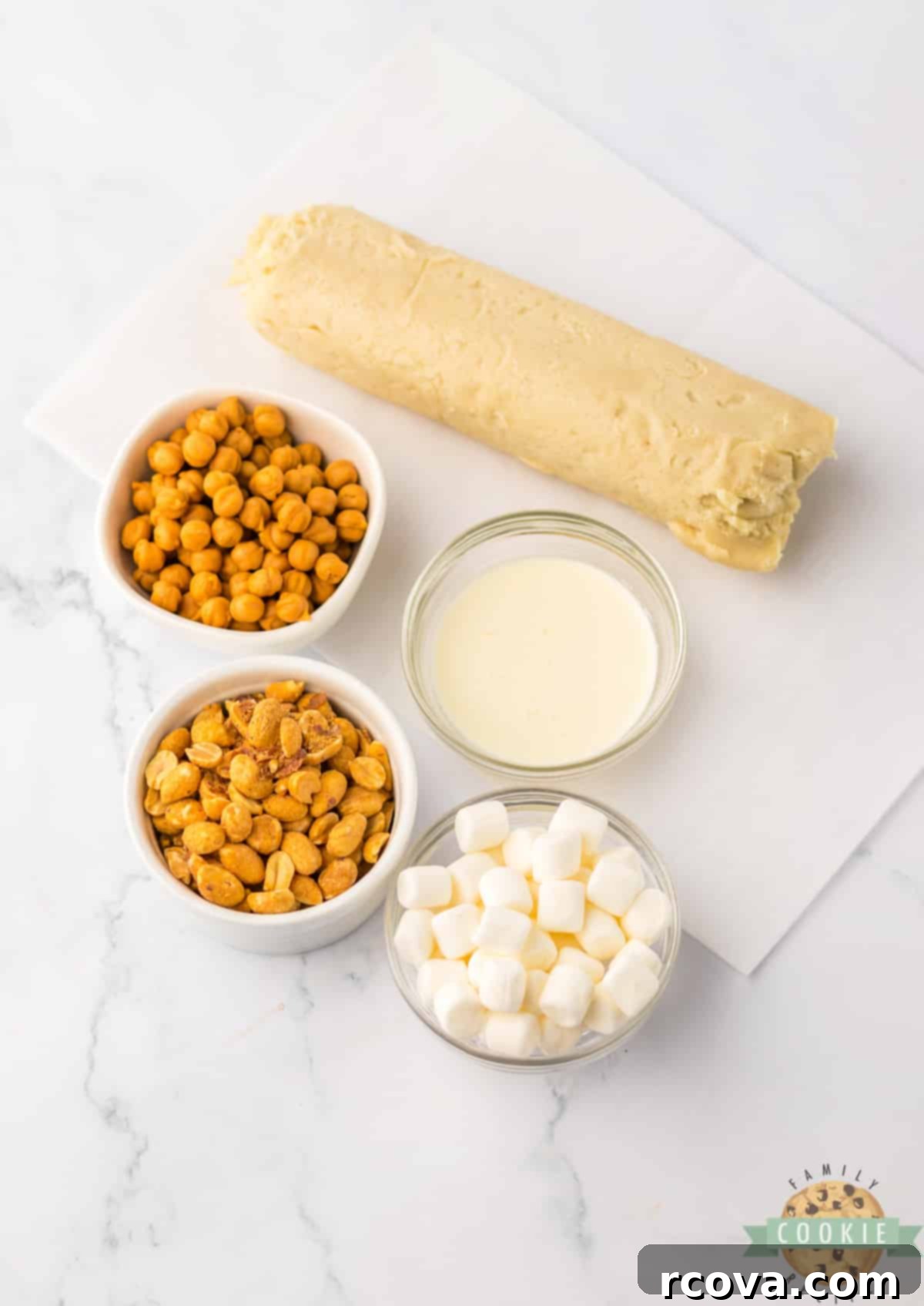Irresistible Peanut Caramel Cookie Bars 5 All the ingredients for Easy Peanut Caramel Cookie Bars laid out: refrigerated sugar cookie dough, caramel bits, heavy whipping cream, peanuts, and mini marshmallows