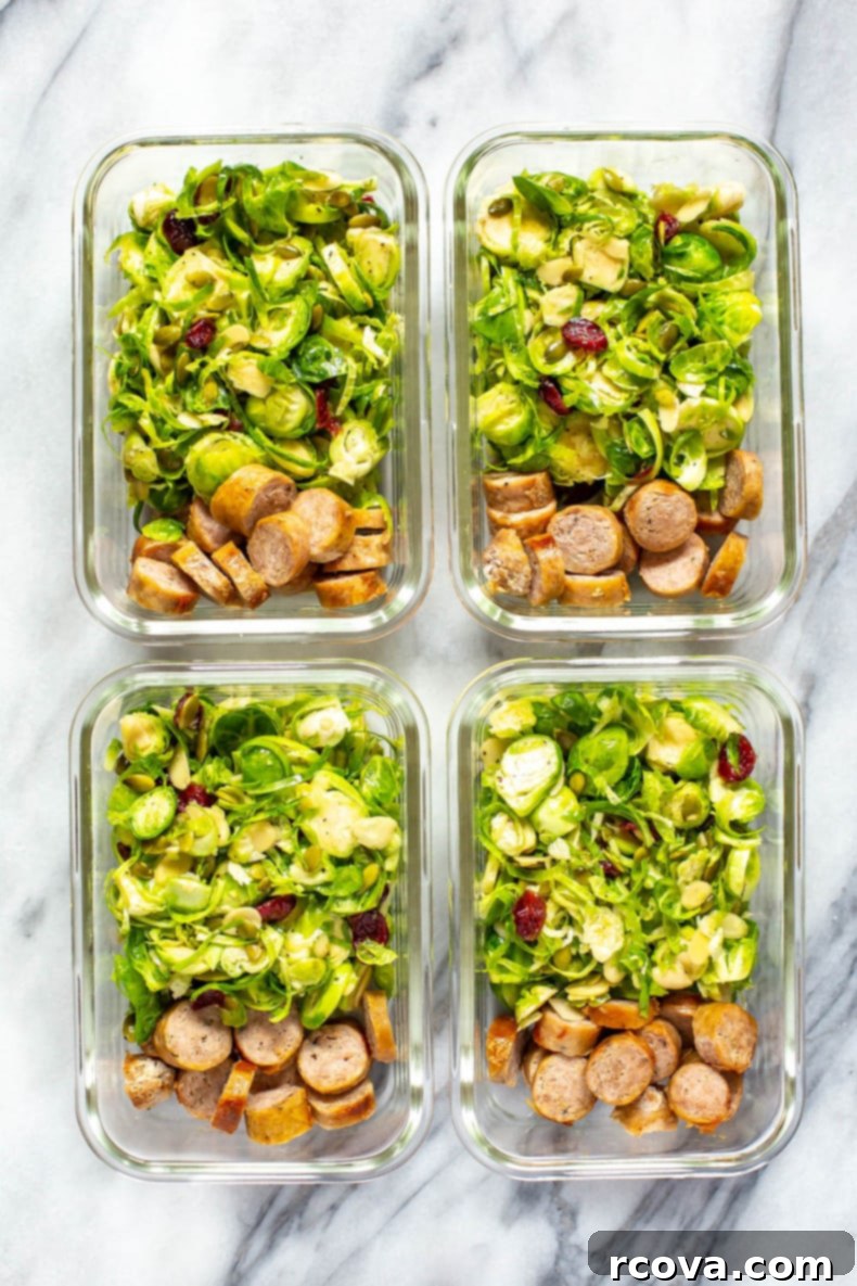 Crisp Brussels Sprout Slaw 9 Two meal prep containers filled with shaved Brussels sprout salad and turkey sausages, ready for a healthy lunch.