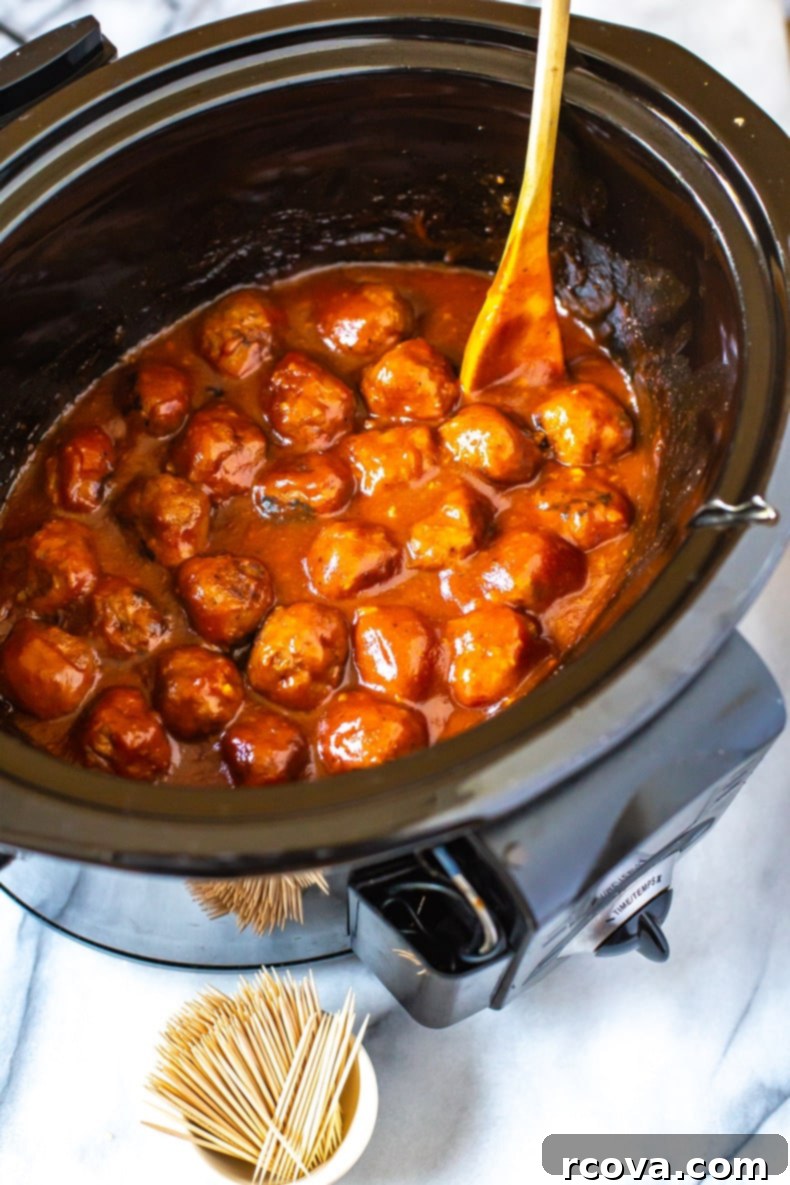 Sticky Honey Garlic BBQ Slow Cooker Meatballs 8 Honey Garlic BBQ Crockpot Meatballs served with toothpicks as an appetizer