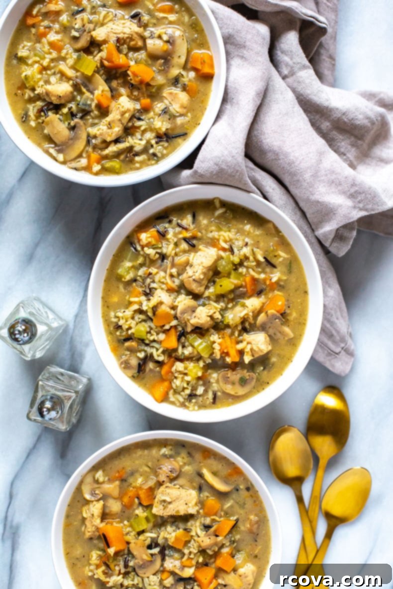 Effortless Comfort Chicken Wild Rice Soup 8 A bowl of delicious chicken wild rice soup with fresh sage garnish