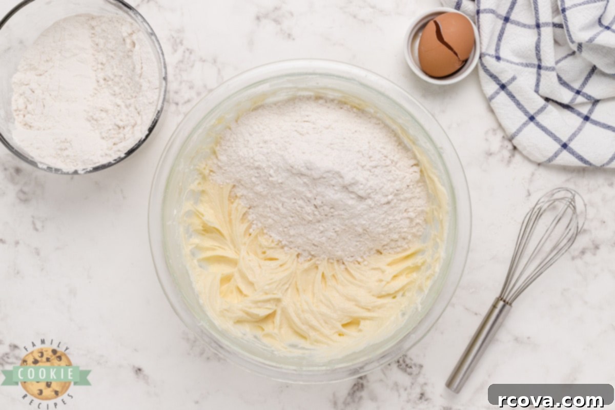 Love-Infused Sugar Delights 9 Dry ingredients, flour and baking powder, being gently mixed into the sugar cookie dough.
