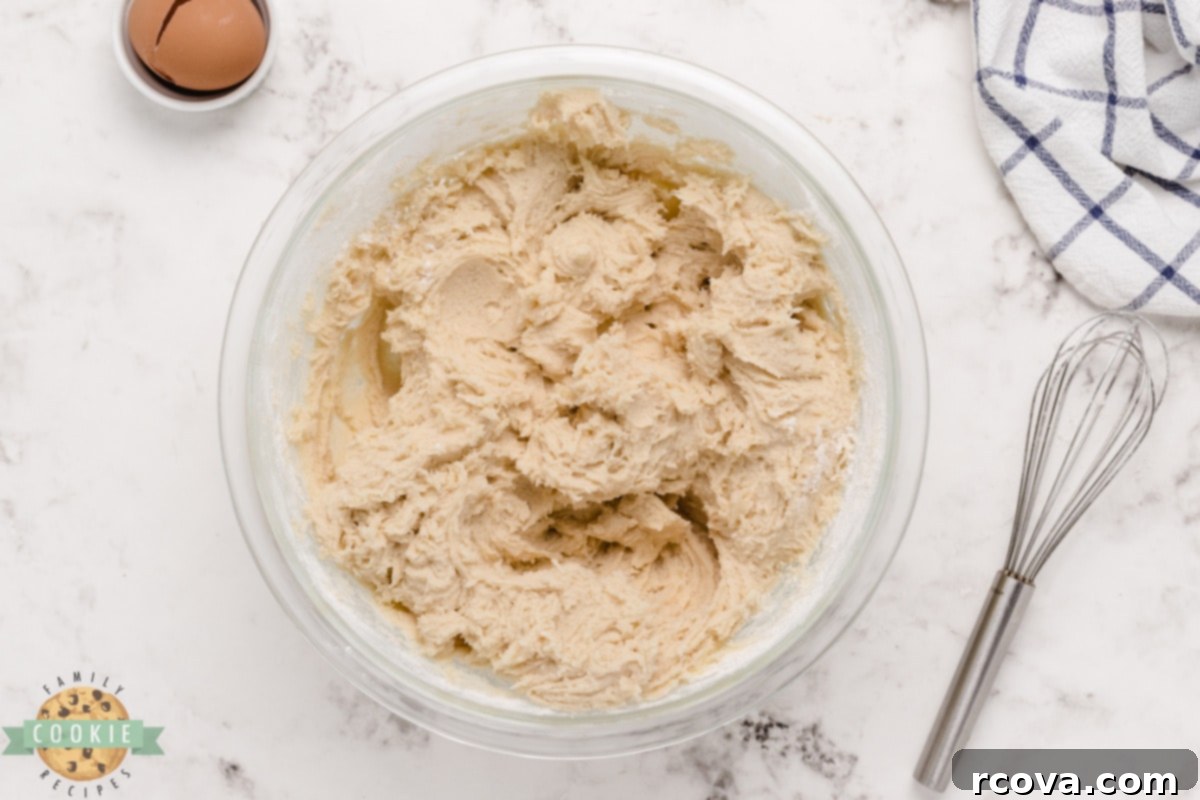Love-Infused Sugar Delights 10 A ball of sugar cookie dough, smooth and ready to be chilled, resting in an airtight container.