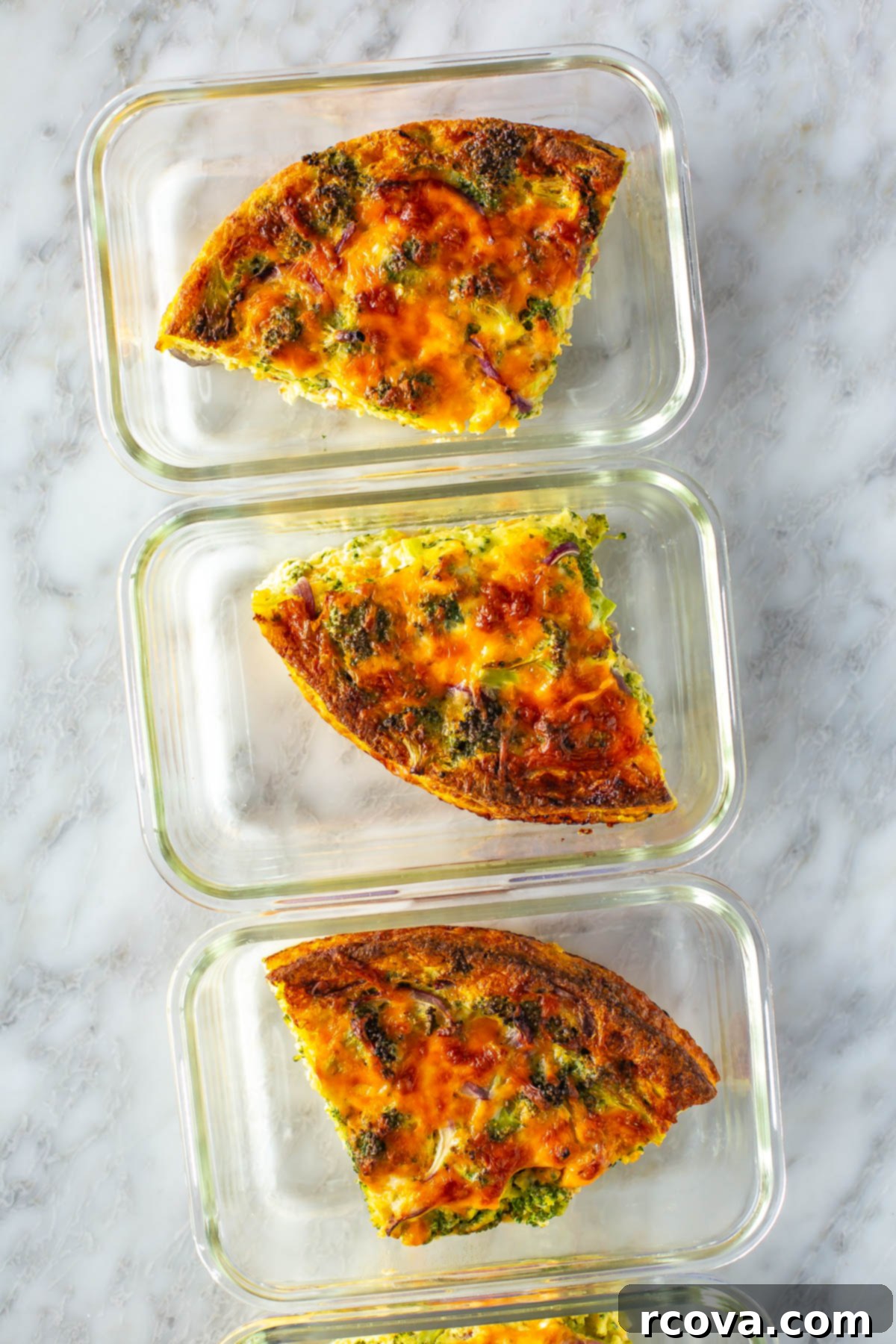Low Carb Crustless Broccoli Cheddar Quiche 9 Individual portions of Crustless Broccoli Cheddar Quiche in glass meal prep containers, ready for the week.