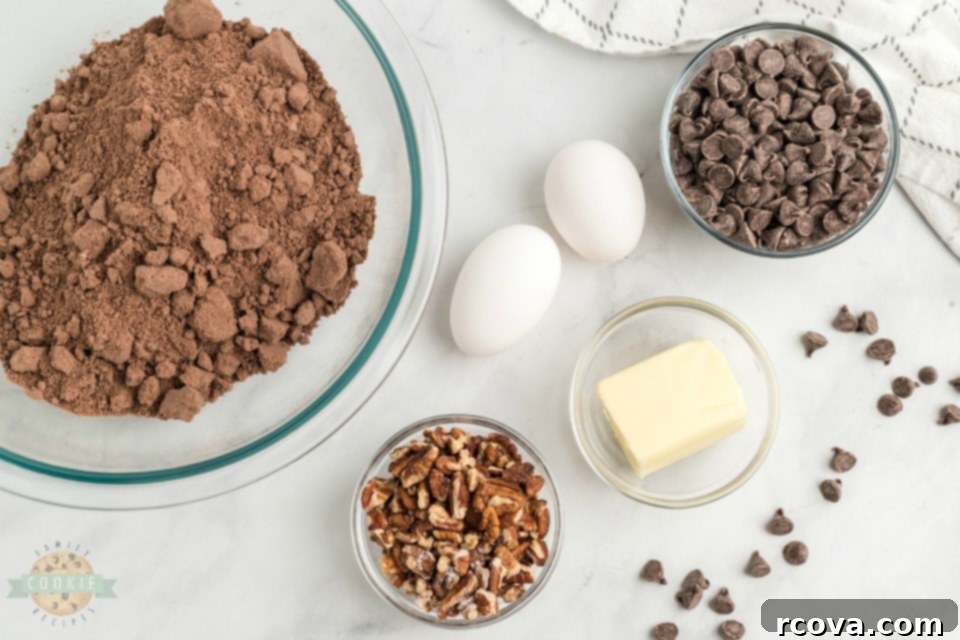 Cake Mix Magic Chocolate Cookies 4 A bowl filled with the five simple ingredients for chocolate cake mix cookies: cake mix, eggs, melted butter, chocolate chips, and chopped pecans.