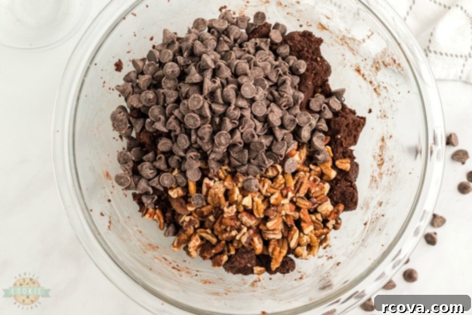 Cake Mix Magic Chocolate Cookies 5 Raw chocolate cake mix cookie dough being scooped onto a baking sheet before baking.