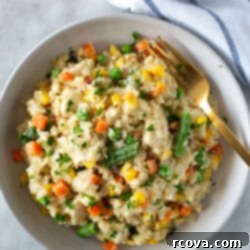 Effortless Slow Cooker Chicken and Rice 10 A beautifully plated bowl of creamy crockpot chicken and rice, garnished with fresh parsley, highlighting its rich and comforting texture.