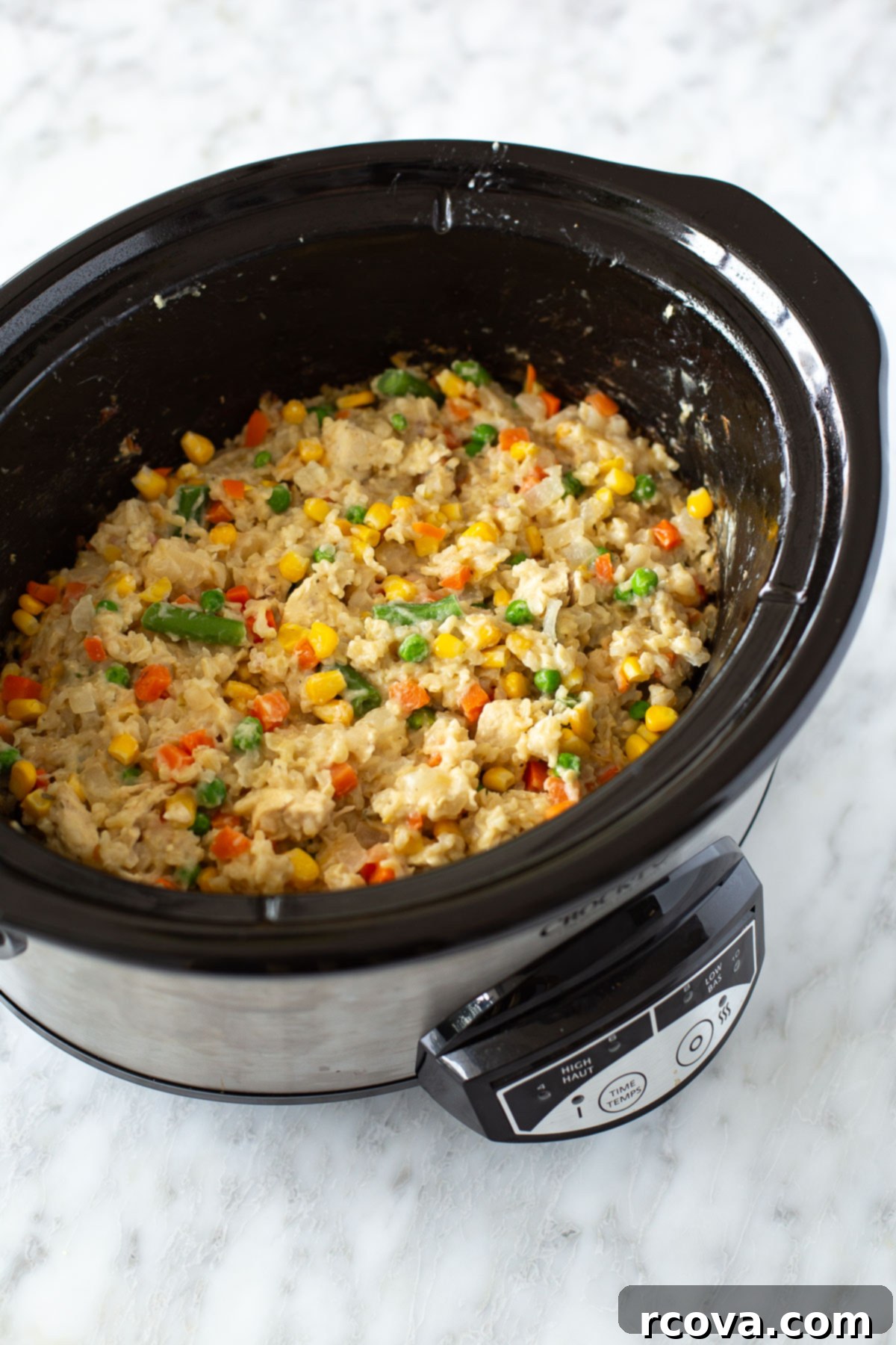 Effortless Slow Cooker Chicken and Rice 7 Close-up shot of creamy crockpot chicken and rice simmering beautifully in a slow cooker, steam gently rising.