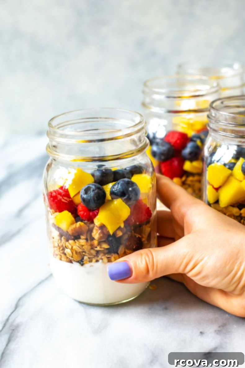 Wholesome Grab and Go Parfaits 7 Completed healthy meal prep yogurt parfaits in mason jars