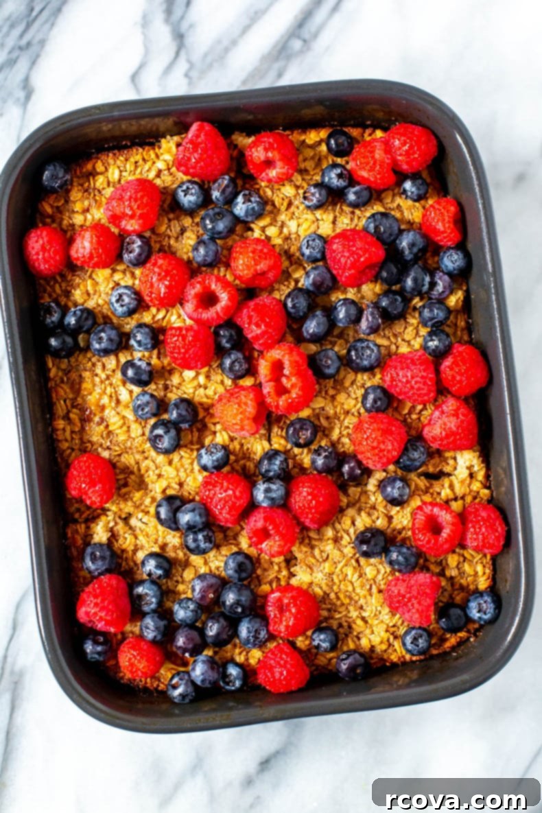 Ultimate Baked Oatmeal 2 Freshly baked oatmeal topped with vibrant fresh berries, ready to be served