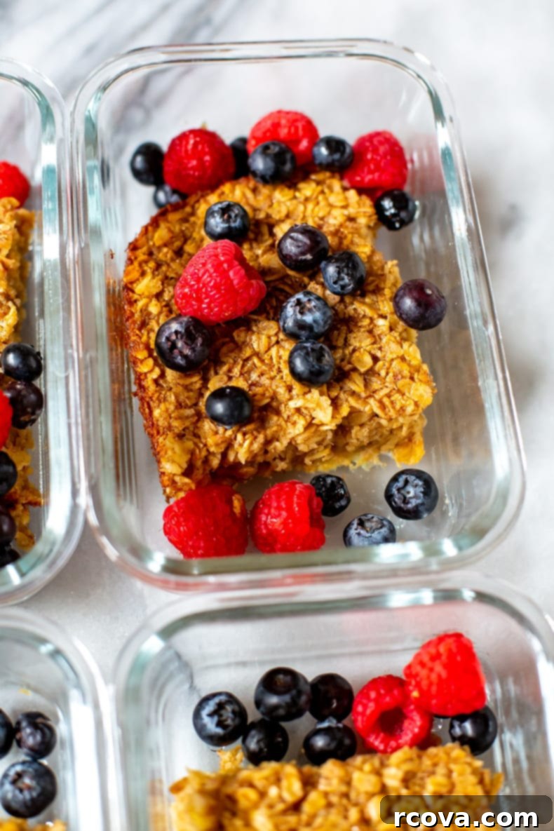 Ultimate Baked Oatmeal 8 Multiple servings of baked oatmeal in meal prep containers, topped with berries