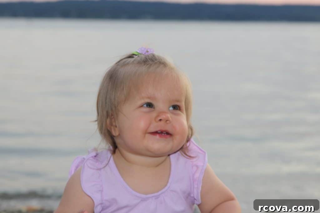 Chewy Fudgy Oat Bars 12 A little girl smiling brightly on a rocky beach, dressed in a warm jacket, looking joyful