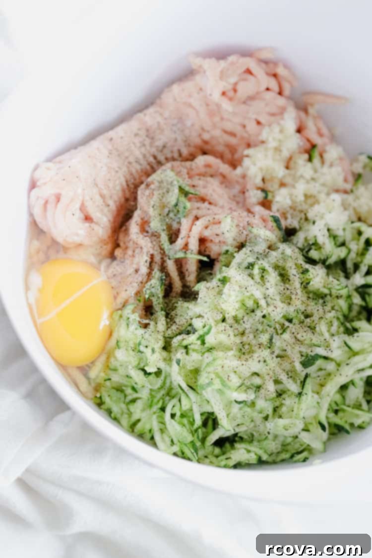Delicious Air Fryer Chicken and Zucchini Meatballs 4 Raw chicken and zucchini meatball mixture in a bowl