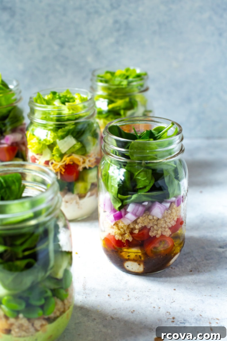 The Ultimate Guide to Meal Prep Containers 6 Overhead shot of a mason jar filled with a colorful, layered simple salad, illustrating an effective meal prep method.