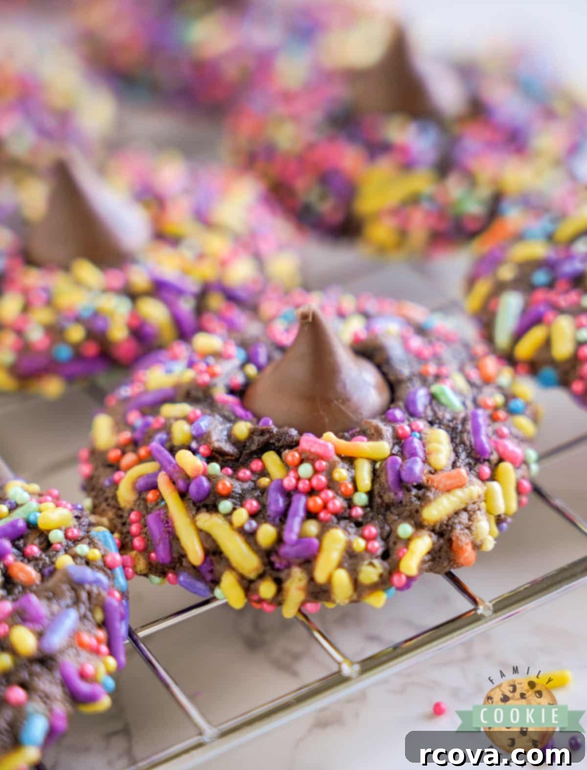 Decadent Easter Brownie Blossoms 2 Easter Brownie Blossom Cookies are rolled in sprinkles before being baked and topped with a Hershey's Kiss. This simple brownie mix cookie recipe is perfect for spring!