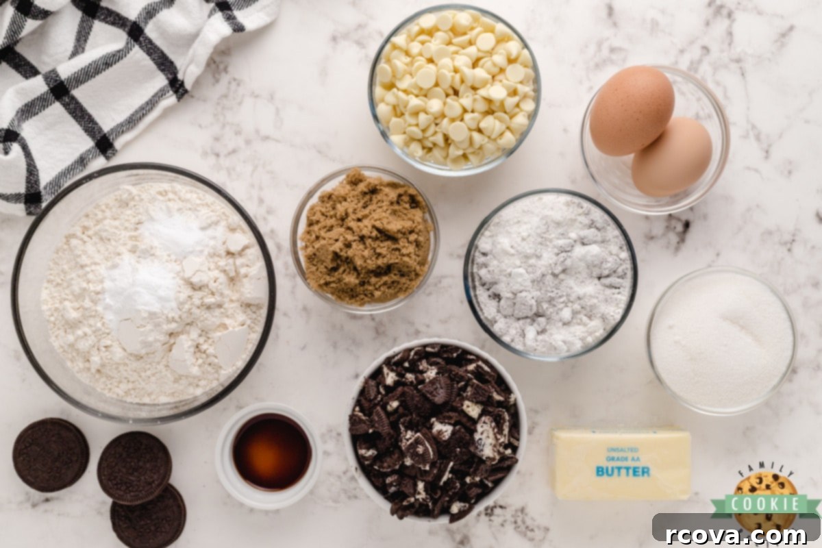 Cookies and Cream Crumble Cookies 6 A selection of high-quality ingredients laid out for making Cookies & Cream Cookies, including butter, sugars, pudding mix, eggs, vanilla, flour, baking soda, white chocolate chips, and Oreo cookies.
