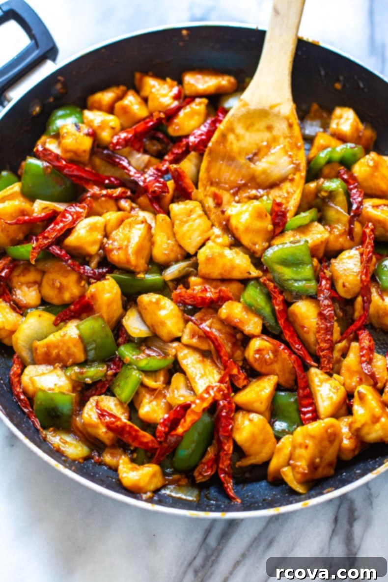Signature Chilli Chicken 8 Chilli Chicken served with jasmine rice and garnished with green onions.
