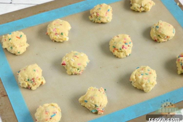 Funfetti Birthday Cake Cookies 6 Baked vanilla cookies with colorful sprinkles on a cooling rack