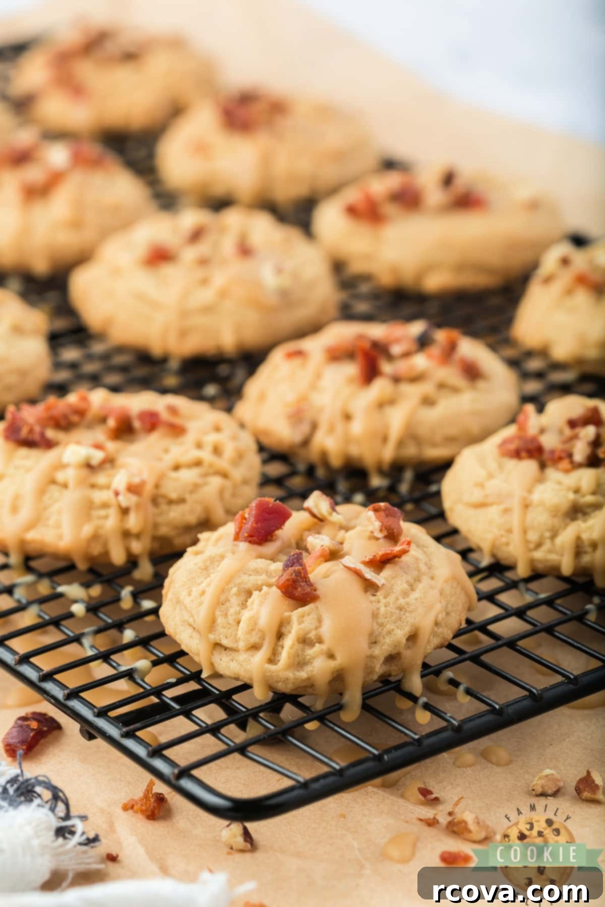 Sweet & Savory Maple Bacon Cookies 2 Close-up of freshly baked Maple Bacon Cookies with maple icing and crumbled bacon on top, showcasing the perfect sweet and savory combination.