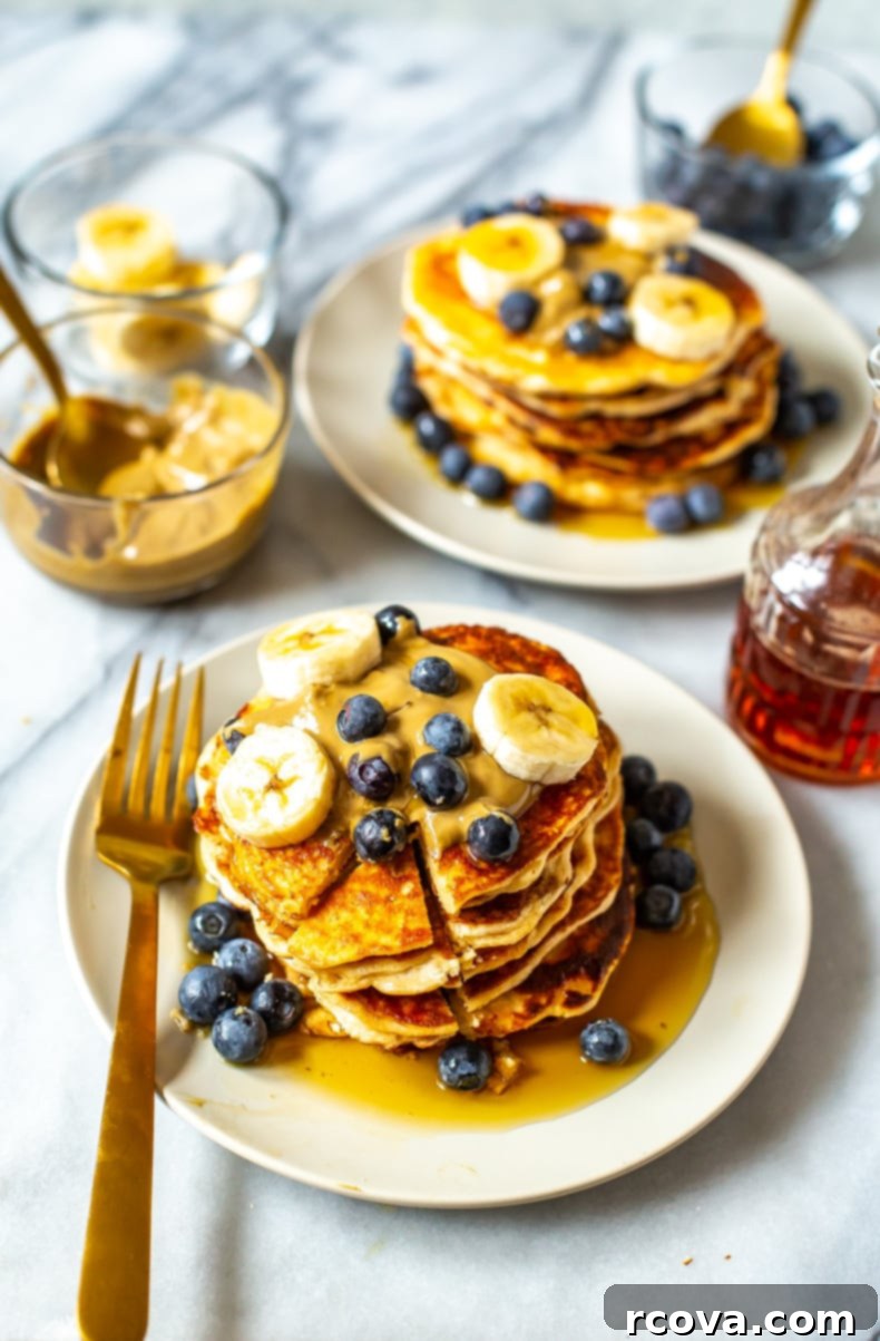 Power-Packed 4-Ingredient Fluffy Pancakes 2 Close-up of fluffy 4-Ingredient Protein Pancakes stacked with fruit