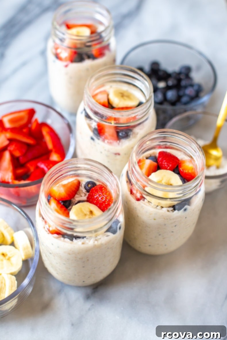 Effortless Morning Oats 2 Beautifully layered Overnight Steel Cut Oats in mason jars, topped with fresh berries and nuts, ready for a healthy meal prep breakfast.