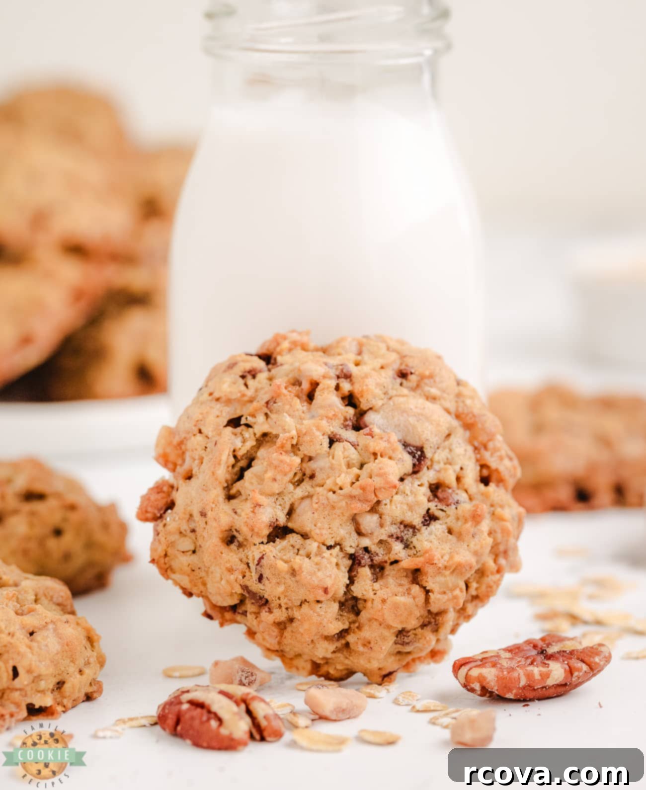 Chewy Toffee Pecan Oatmeal Delights 3 Close-up of an oatmeal toffee pecan cookie with a glass of milk, highlighting its enticing texture