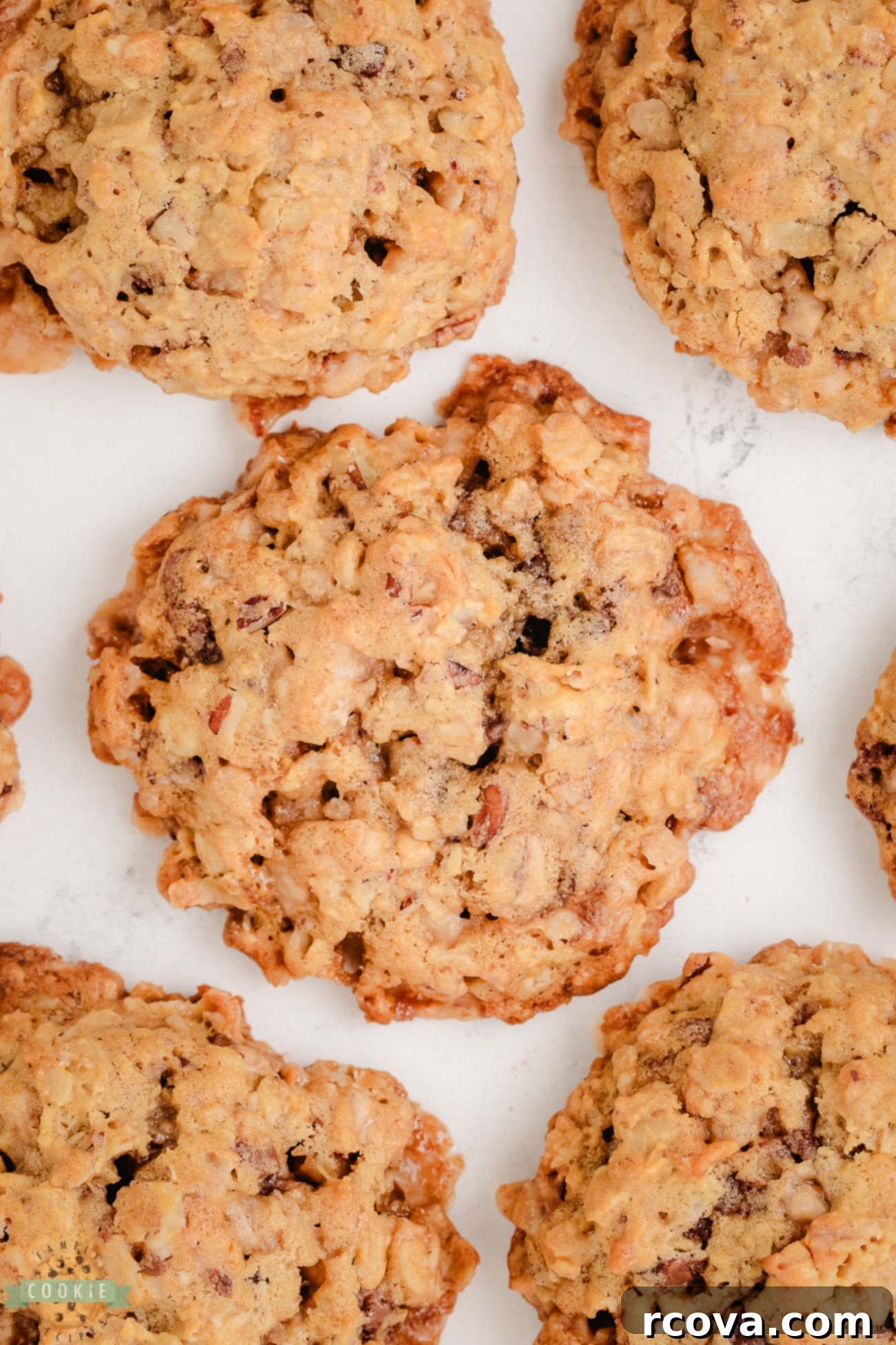 Chewy Toffee Pecan Oatmeal Delights 7 Freshly baked oatmeal toffee pecan cookies cooling on a baking sheet, golden brown and perfectly textured