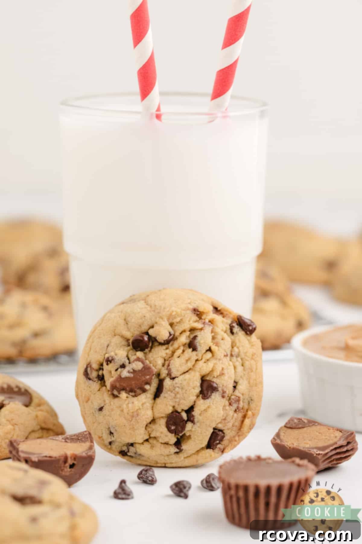 Reese's Peanut Butter Pudding Cookies 6 A delicious Reese's Peanut Butter Pudding Cookie with visible peanut butter cups and a cold glass of milk, ready to be enjoyed.