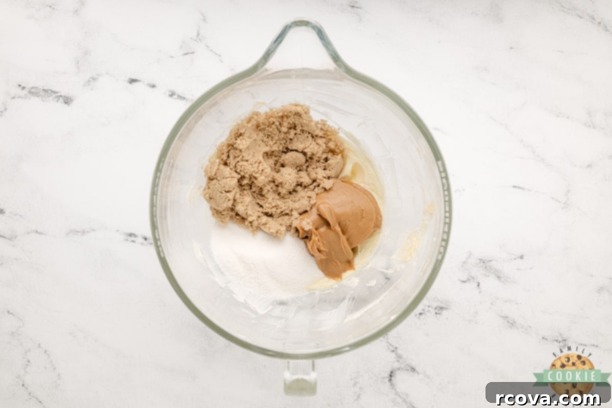 Reese's Peanut Butter Pudding Cookies 8 Adding granulated sugar, brown sugar, and creamy peanut butter to the creamed butter in a bowl.
