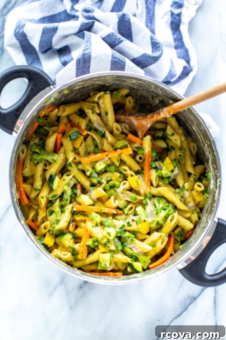 Effortless One-Pot Spring Pasta 9 One Pot Pasta Primavera served in a bowl, with a fork, ready to eat