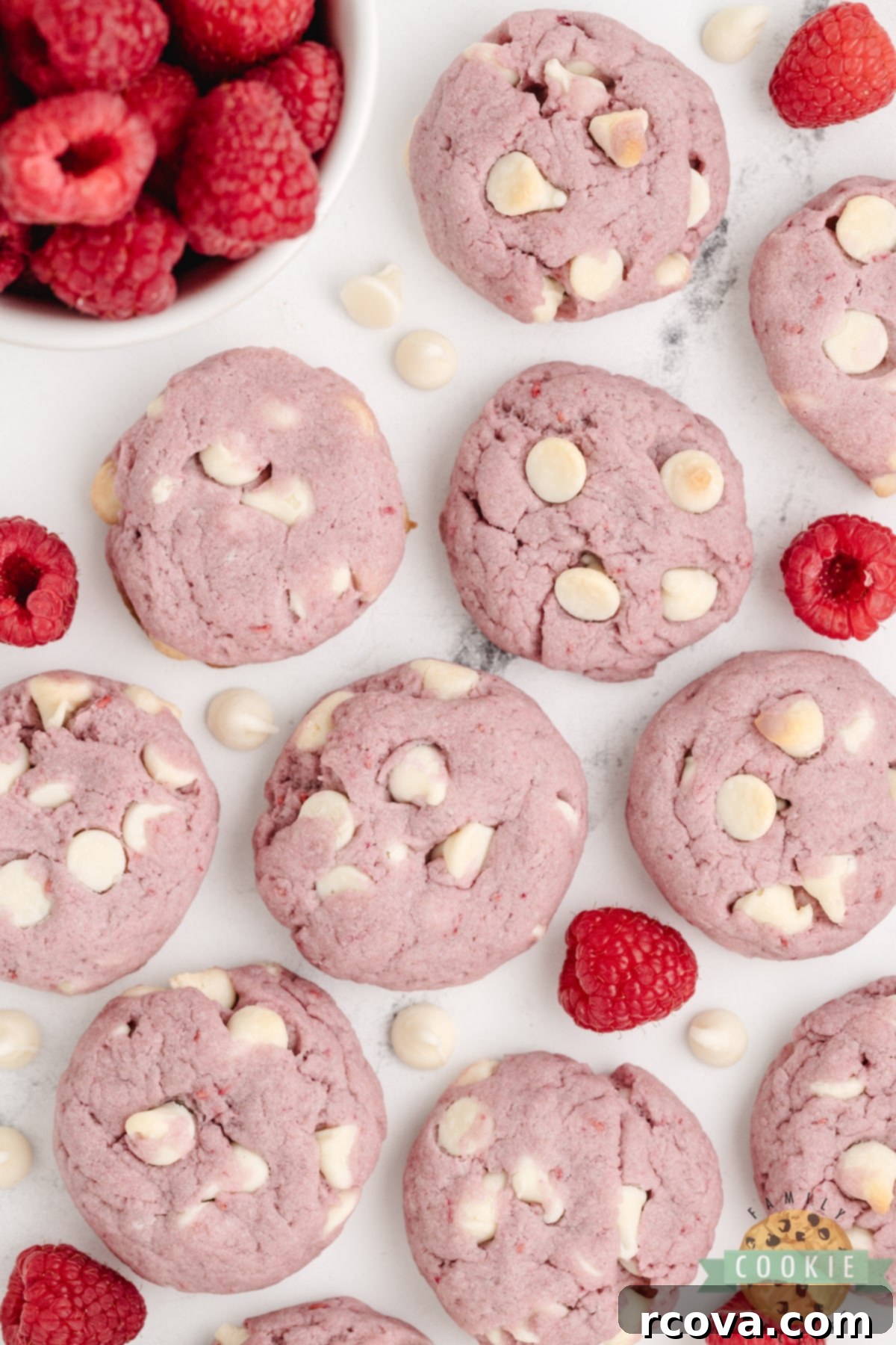 Ruby Red Raspberry Bites 13 A stack of perfectly pink Raspberry Cookies with white chocolate chips on a white plate.