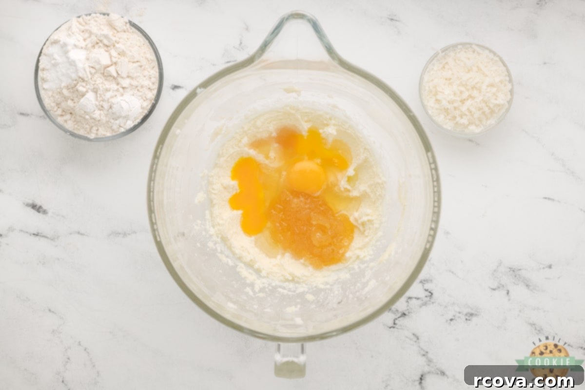 Piña Colada Paradise Bites 9 Add eggs and pineapple topping to creamed butter and sugar.