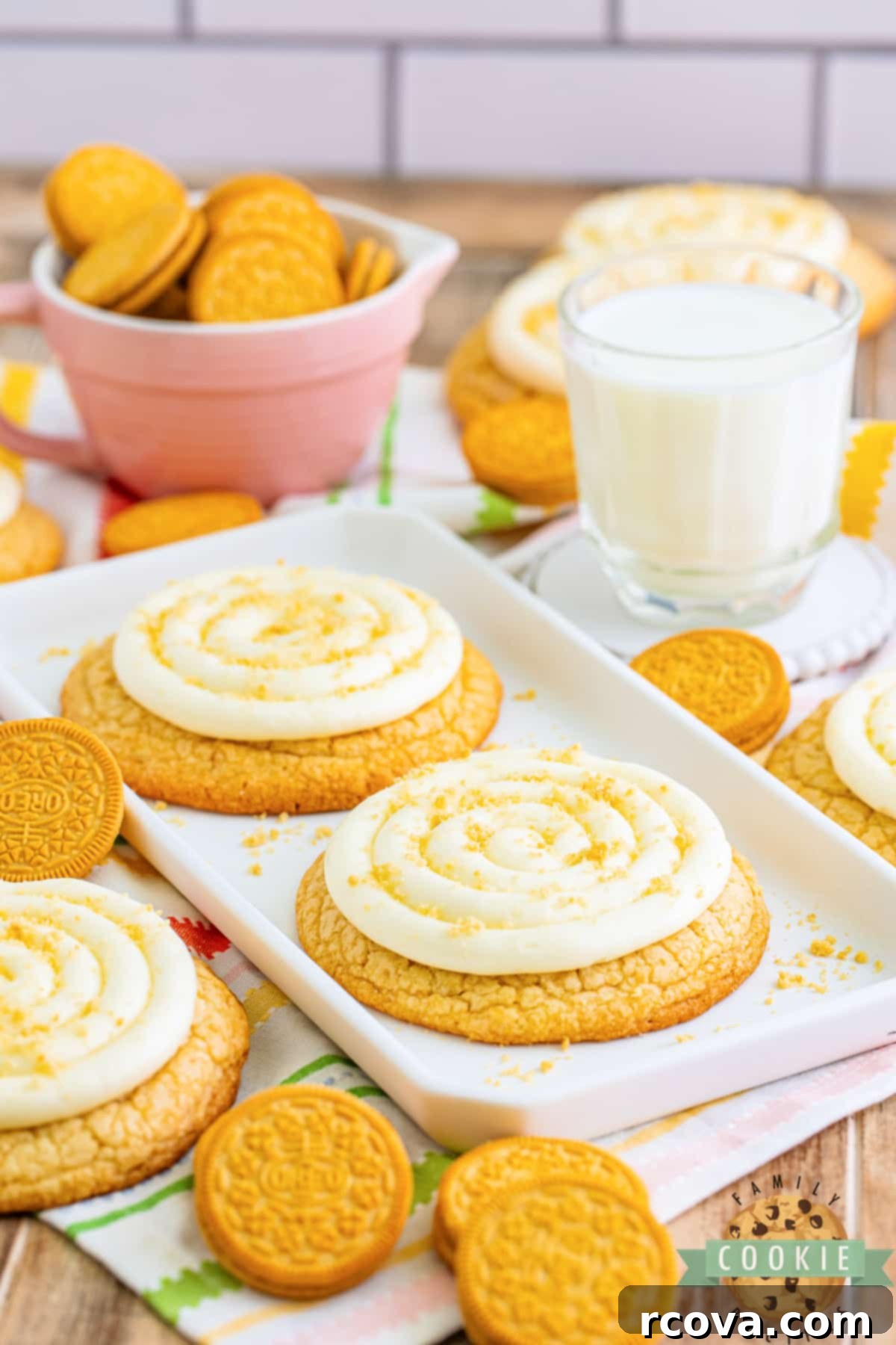 Crumbl-Inspired Golden Oreo Cookies 14 A stack of three Copycat Crumbl Golden Oreo Cookies with creamy frosting and crumb topping, tempting and delicious.