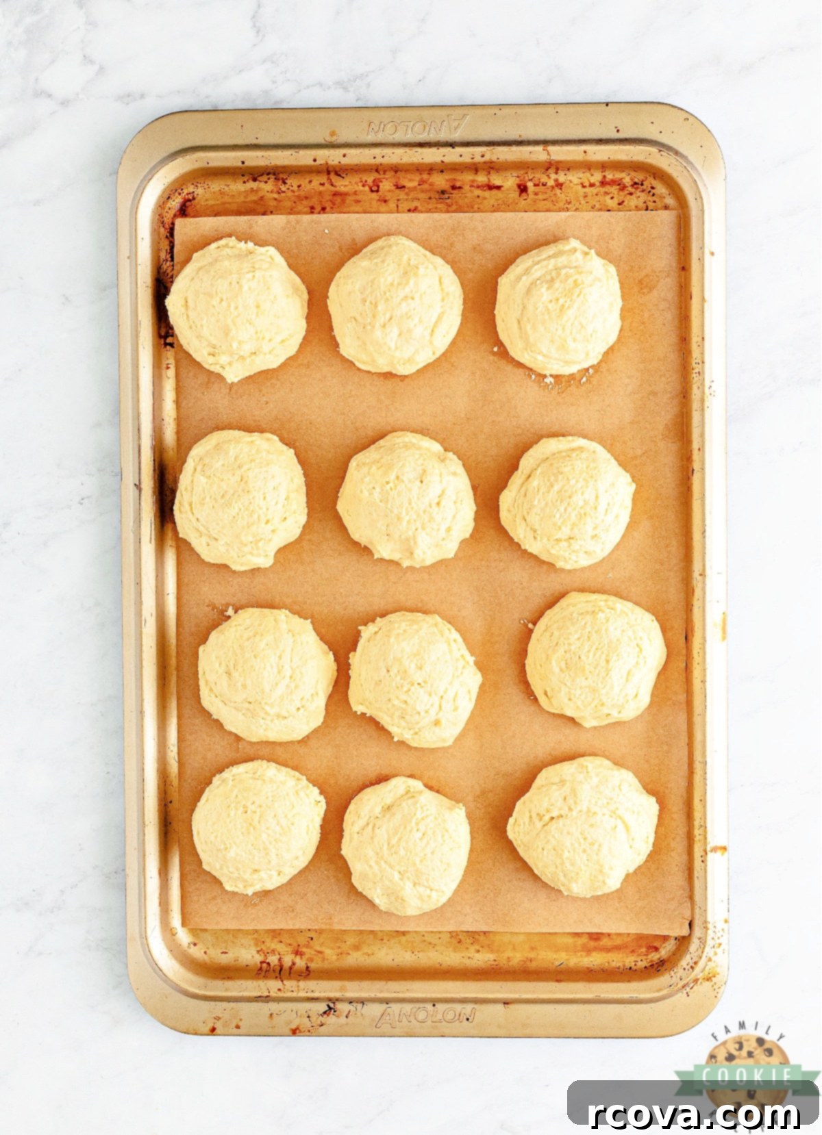 Crumbl-Inspired Golden Oreo Cookies 8 Cookie dough divided into 12 large portions on a parchment-lined sheet tray, ready for chilling.