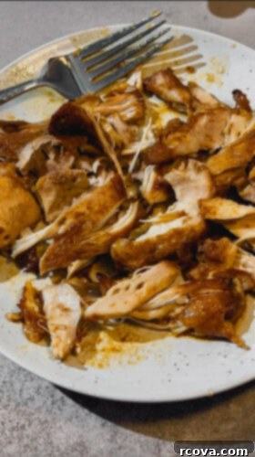Simply Wholesome Slow Cooker Sesame Chicken 5 Mixing shredded sesame chicken back into the sauce in the crockpot