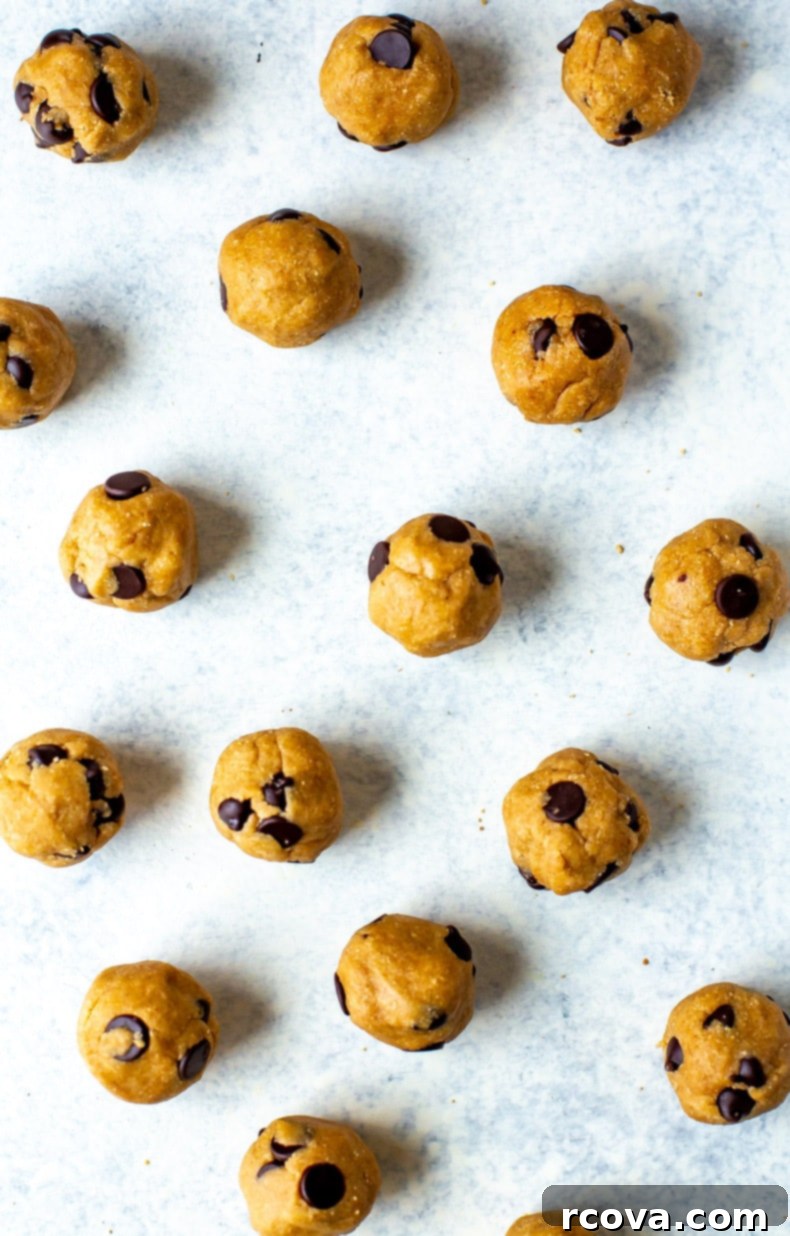Guilt-Free Raw Cookie Dough 10 Large scoop of healthy edible cookie dough with chocolate chips on a marble background.